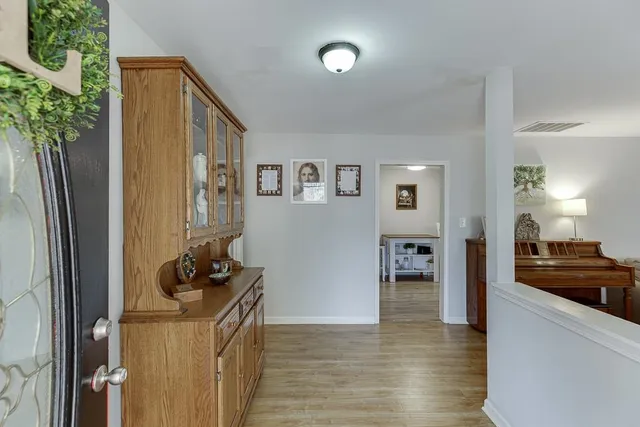 a view of living room with furniture and a kitchen