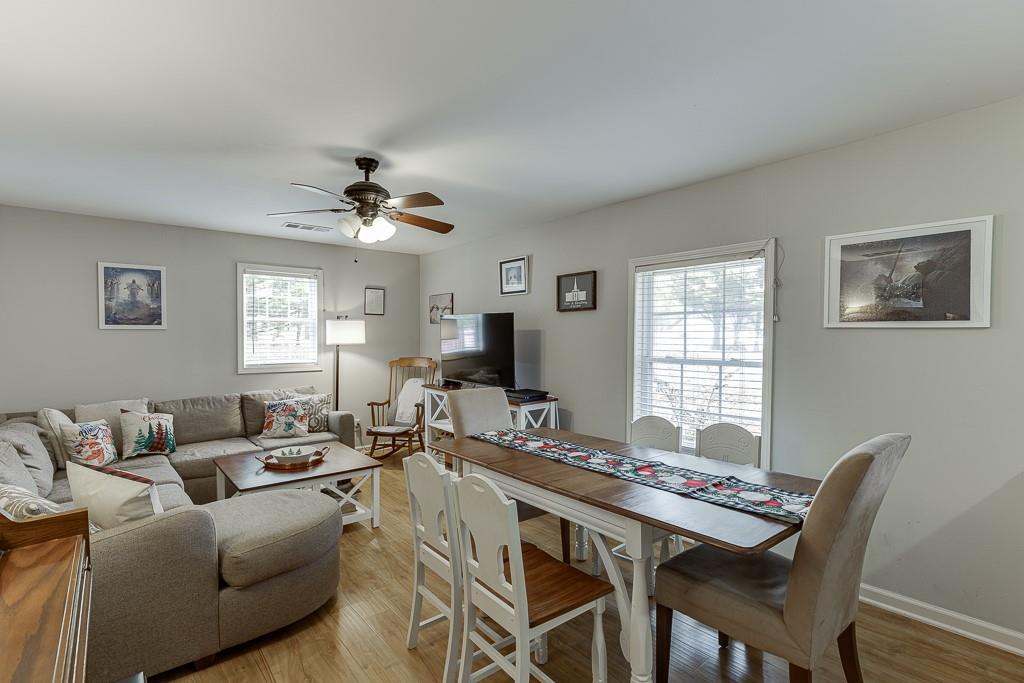 2838 North Bogan Road Northeast Buford, GA 30519 - Photo 6 of 39 a living room with furniture a chandelier and a window