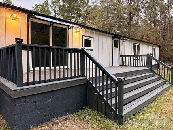 a view of a house with wooden deck