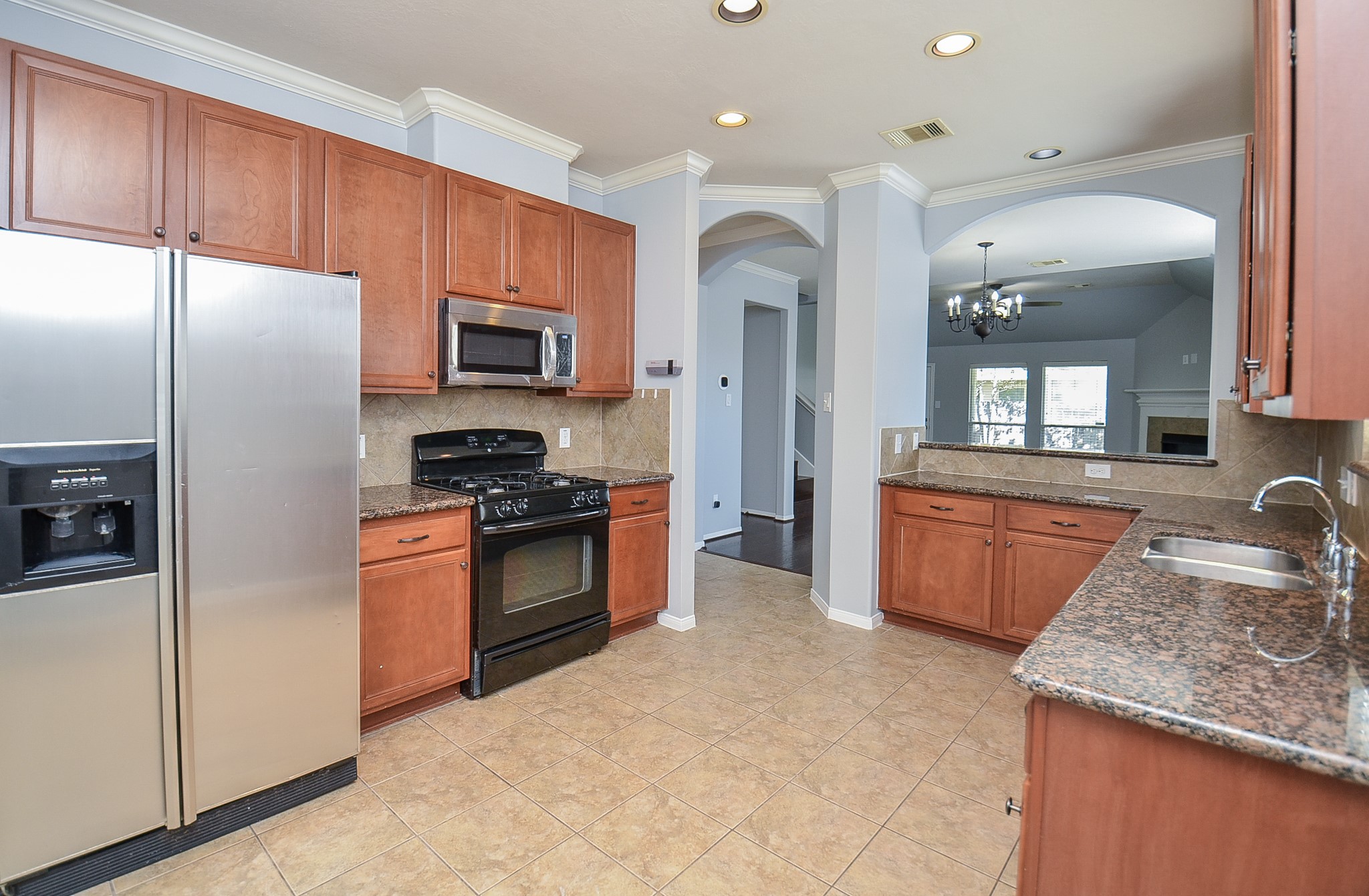 25226 Diamond Ranch Drive Katy, TX 77494 - Photo 10 of 28 a kitchen with granite countertop stainless steel appliances and wooden cabinets
