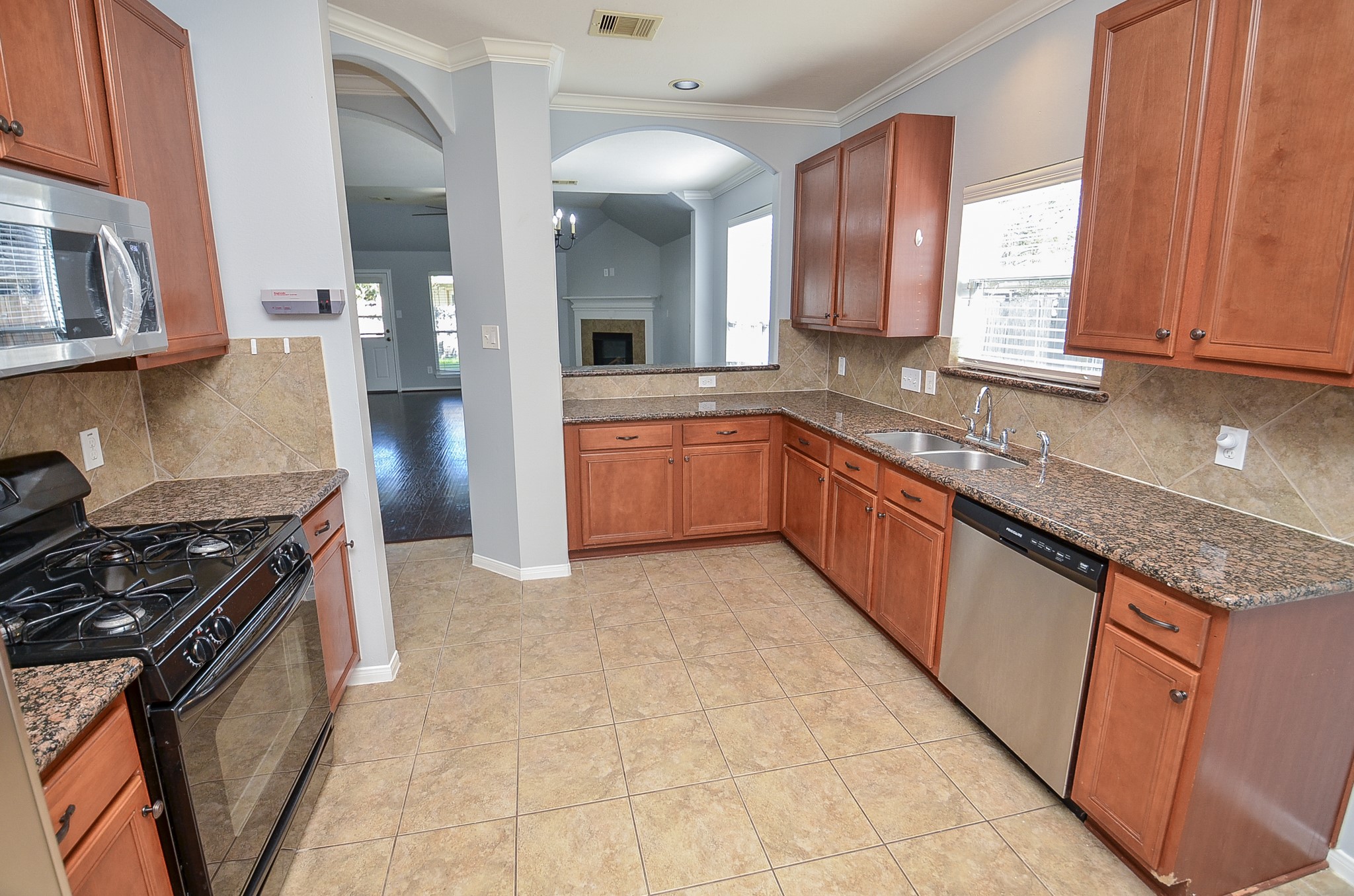 25226 Diamond Ranch Drive Katy, TX 77494 - Photo 11 of 28 a kitchen with granite countertop a sink stove and cabinets