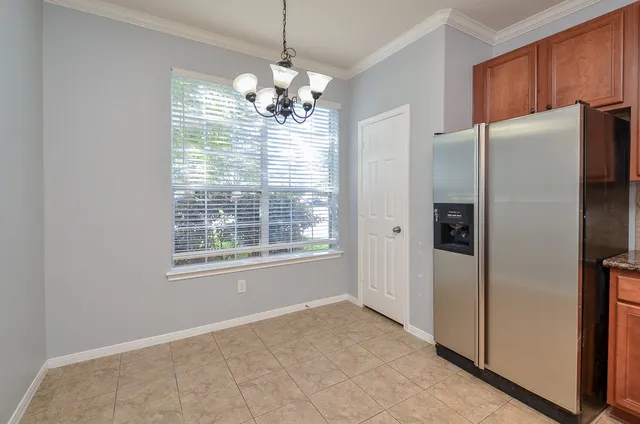 a kitchen with granite countertop a sink window and cabinets