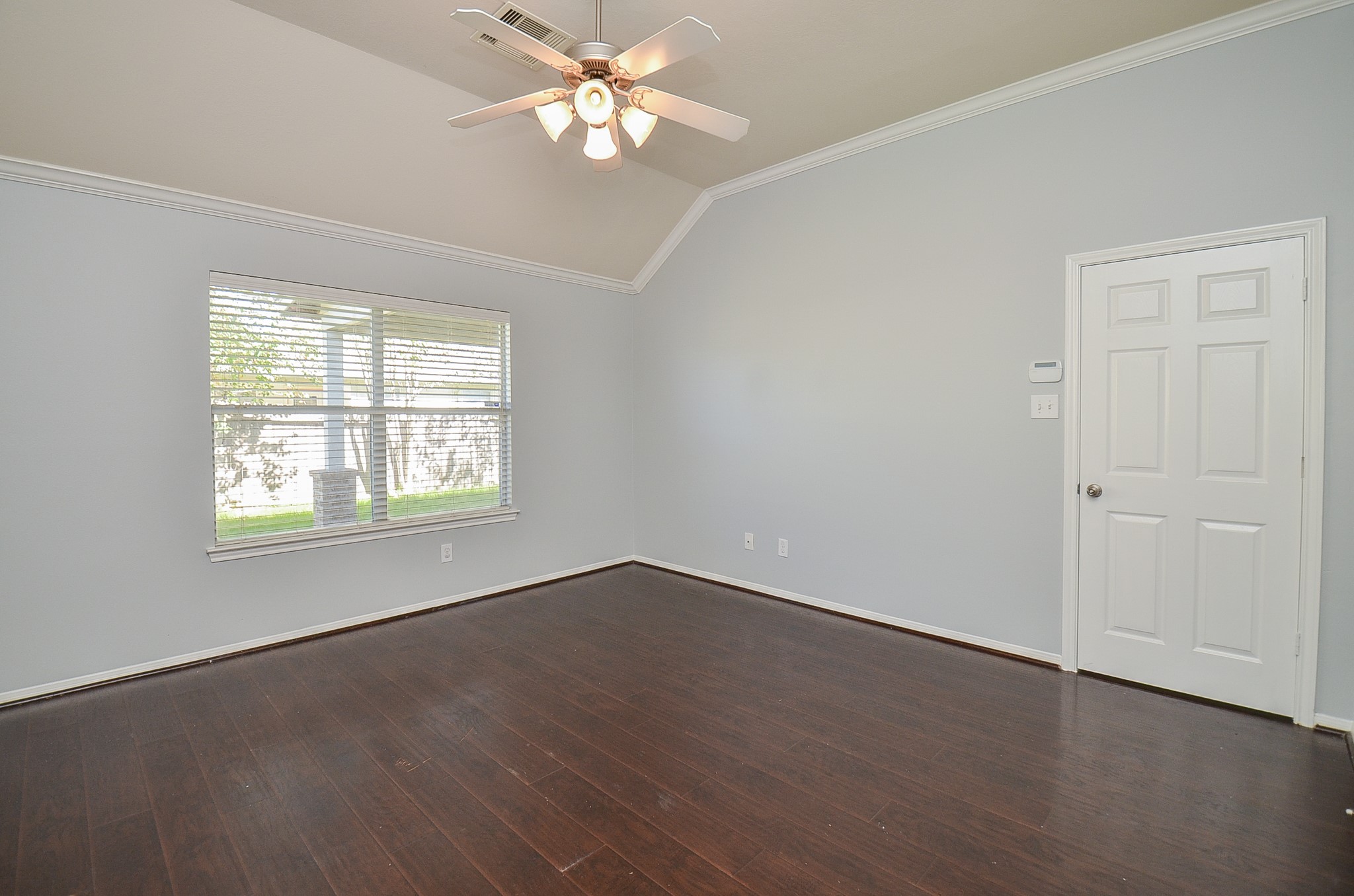 25226 Diamond Ranch Drive Katy, TX 77494 - Photo 14 of 28 an empty room with wooden floor chandelier fan and windows