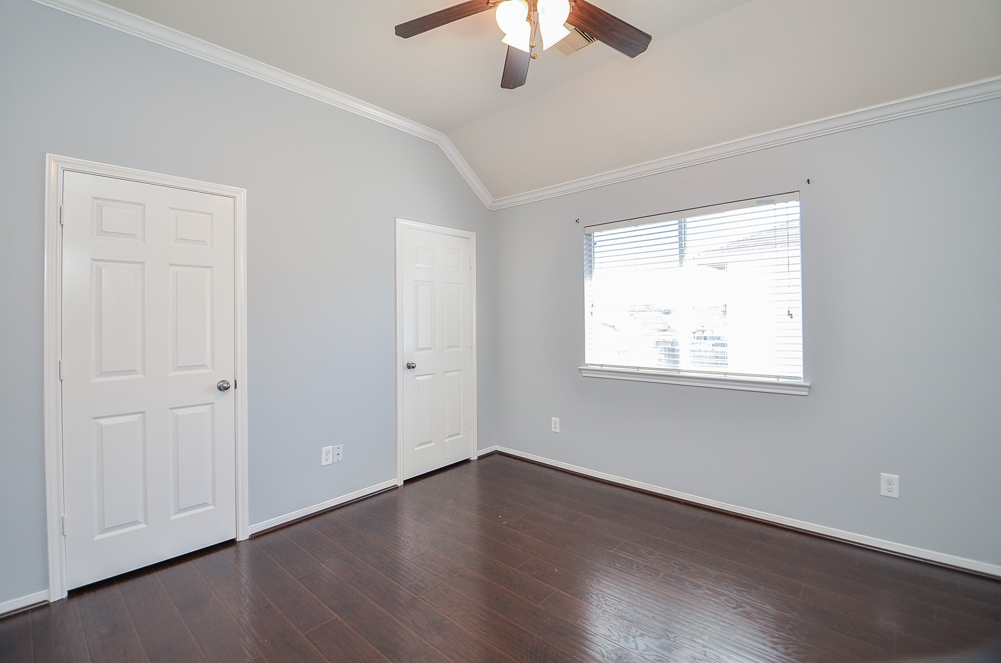 25226 Diamond Ranch Drive Katy, TX 77494 - Photo 20 of 28 an empty room with wooden floor chandelier fan and windows