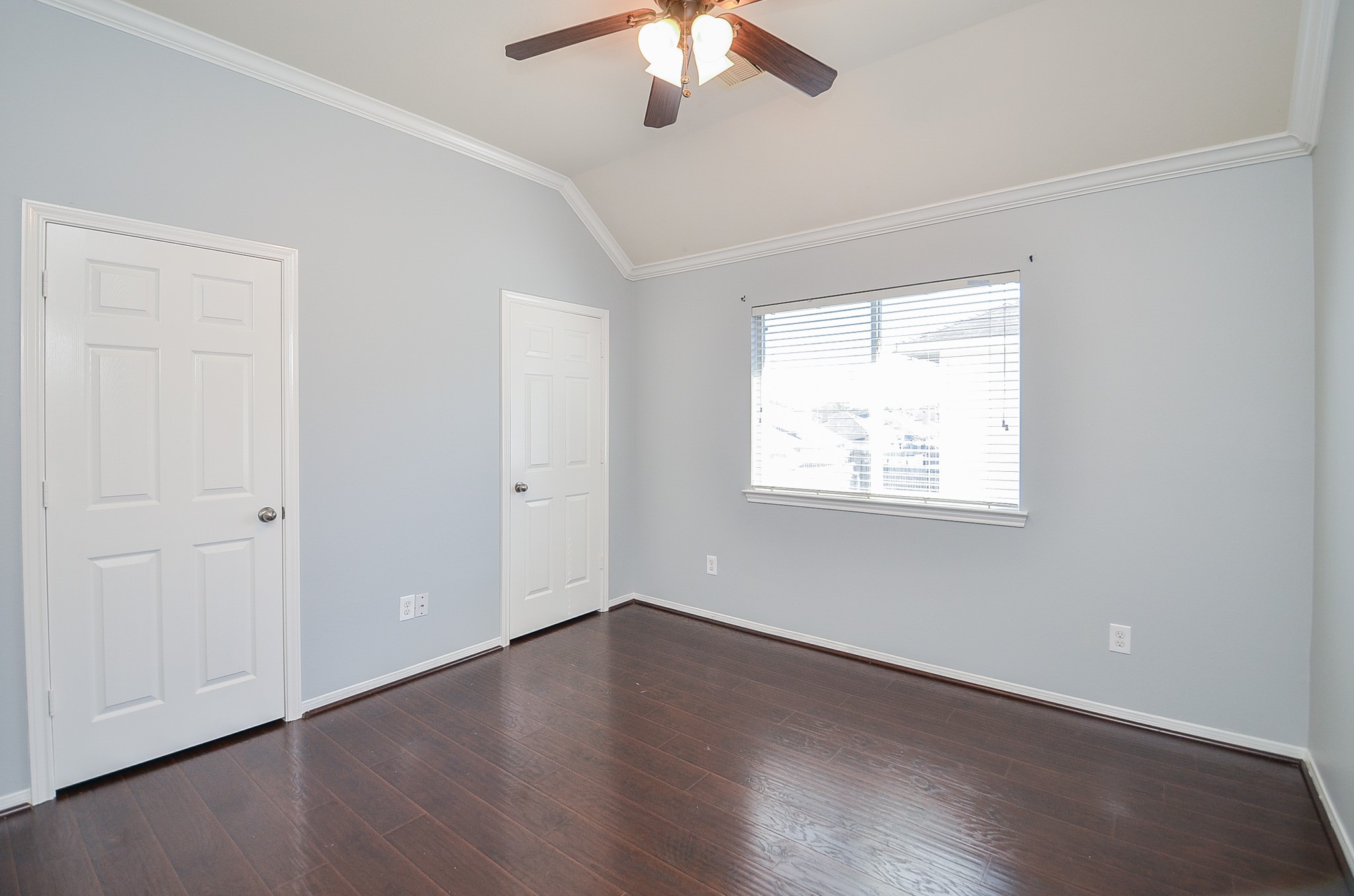 25226 Diamond Ranch Drive Katy, TX 77494 - Photo 21 of 28 an empty room with wooden floor chandelier fan and windows