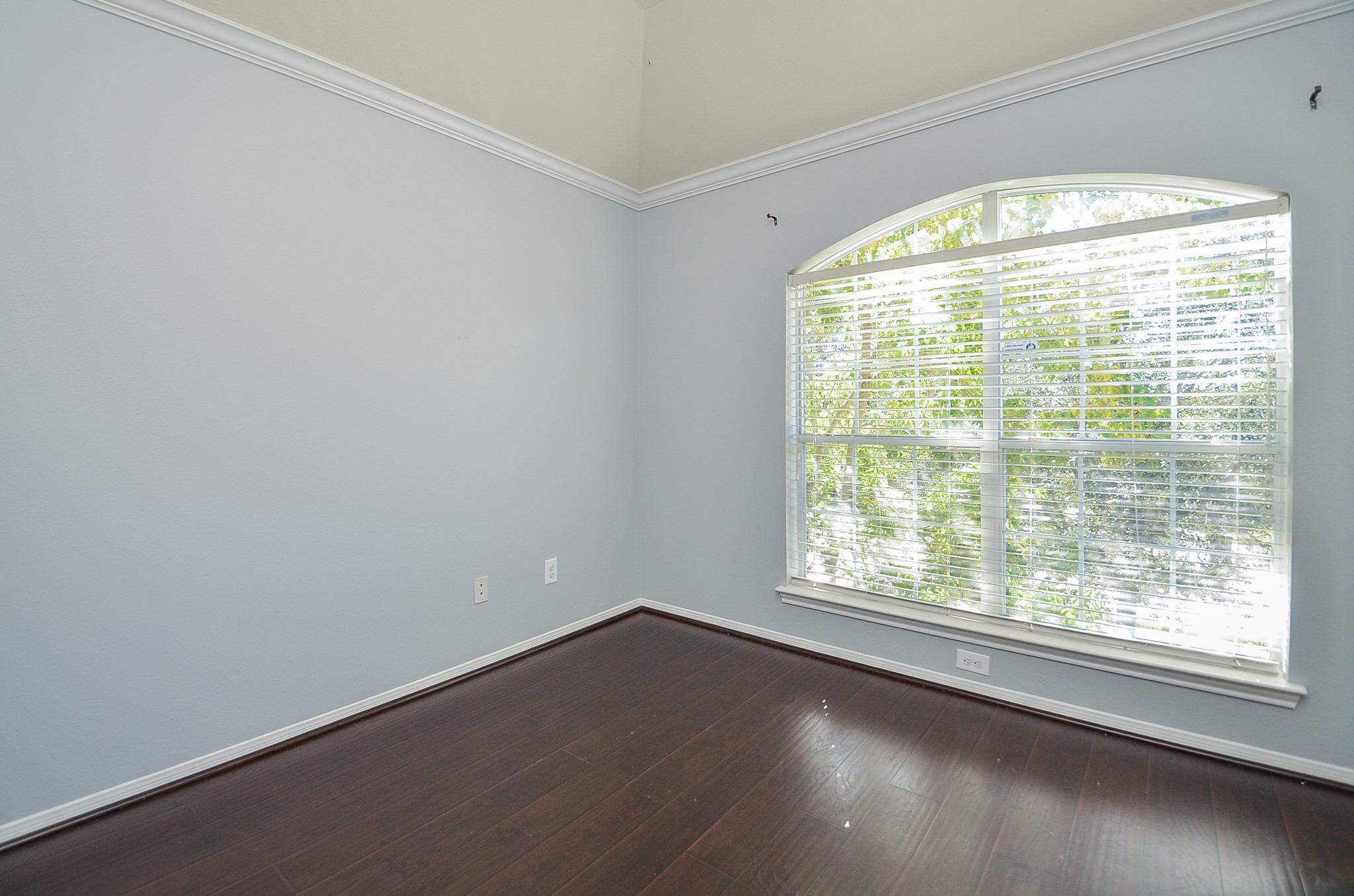 25226 Diamond Ranch Drive Katy, TX 77494 - Photo 22 of 28 a view of an empty room with wooden floor and a window