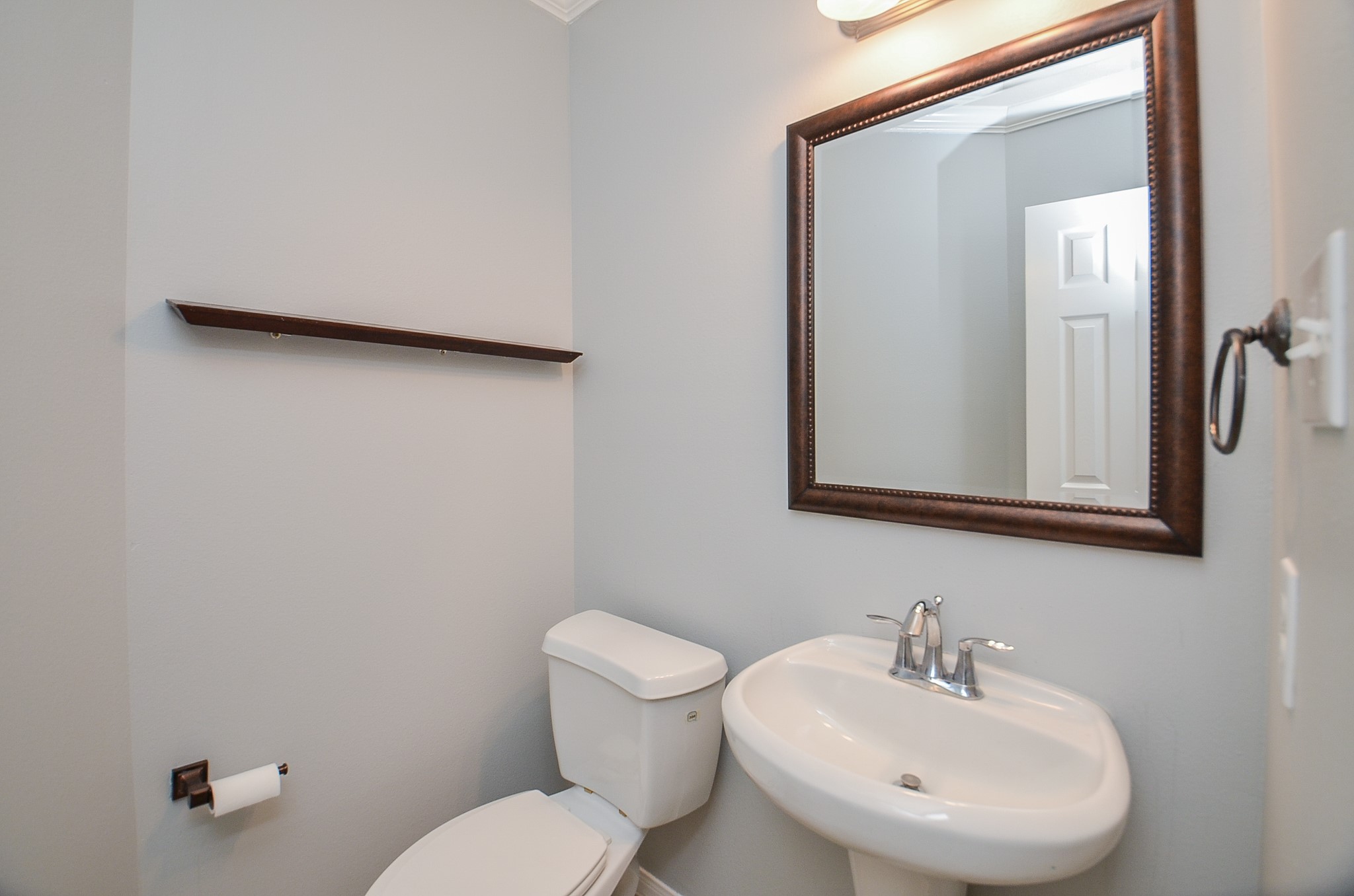 25226 Diamond Ranch Drive Katy, TX 77494 - Photo 24 of 28 a bathroom with a toilet a sink and mirror