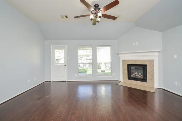 wooden floor chandelier and windows in a room