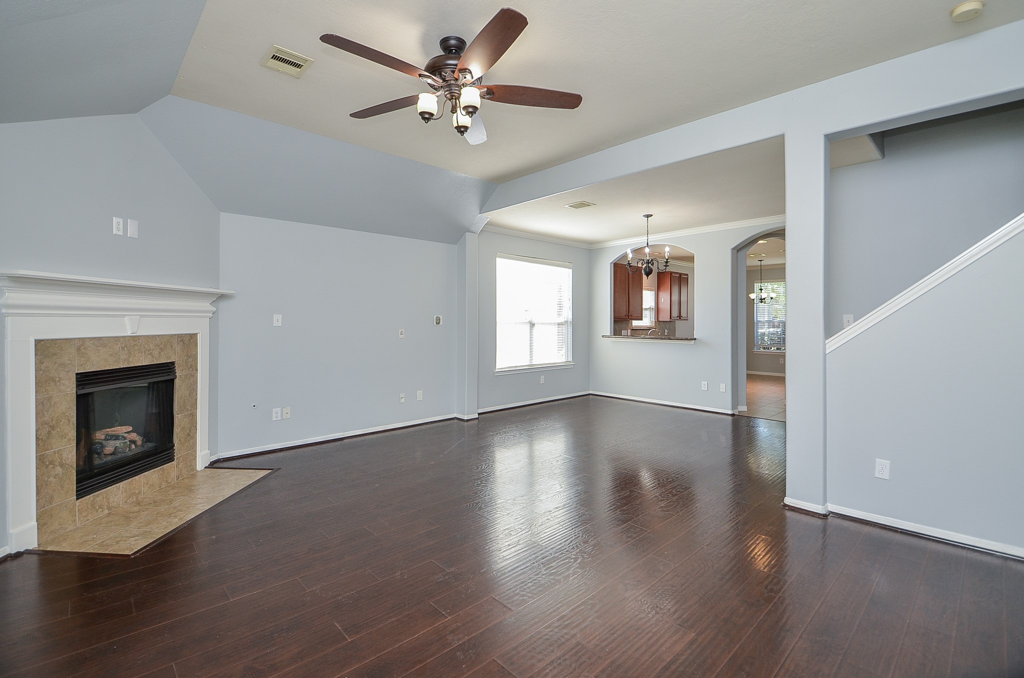 25226 Diamond Ranch Drive Katy, TX 77494 - Photo 28 of 28 an empty room with wooden floor fireplace and windows