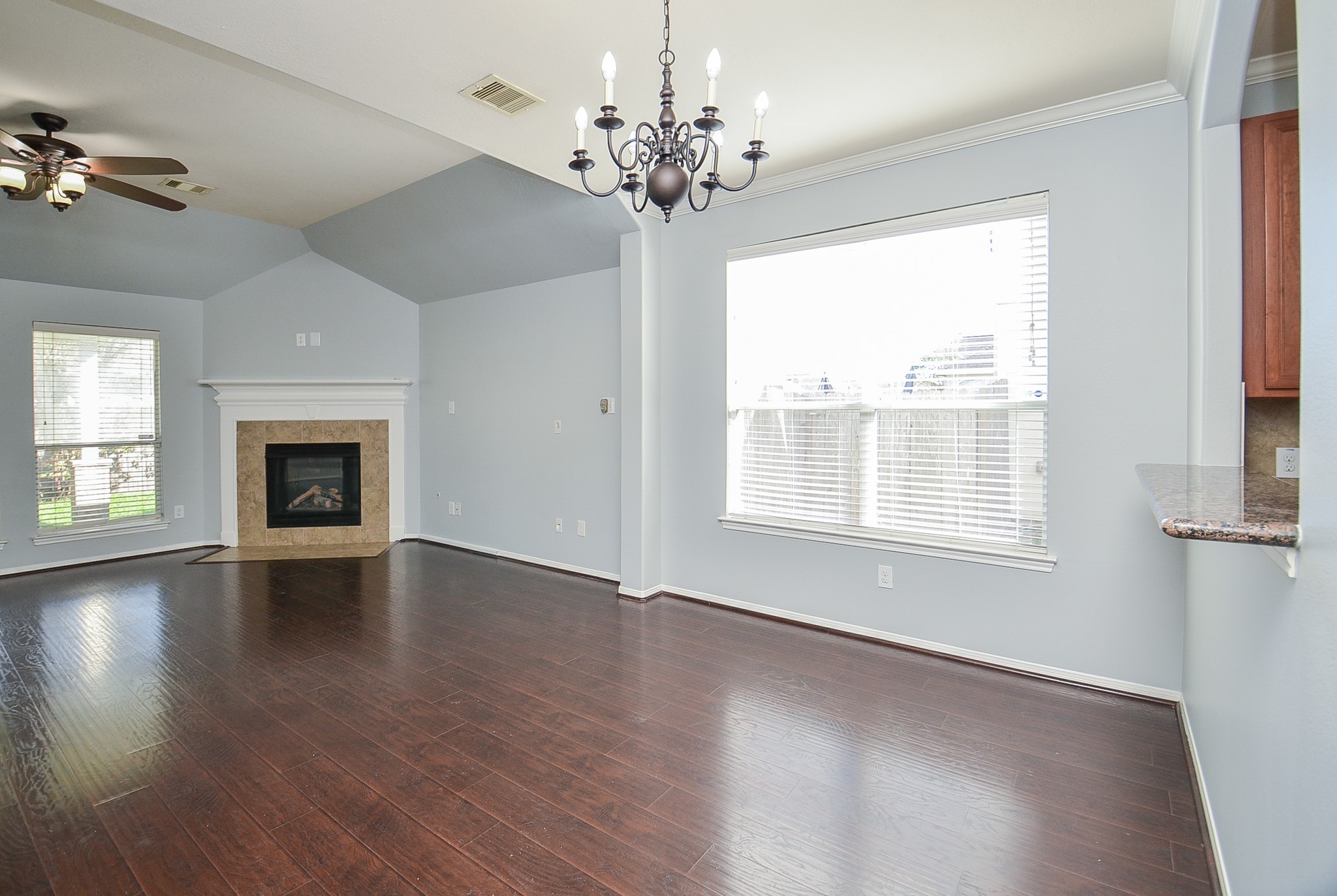 25226 Diamond Ranch Drive Katy, TX 77494 - Photo 8 of 28 an empty room with wooden floor chandelier and windows