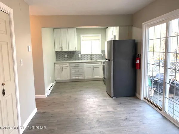 a kitchen with a refrigerator and a stove