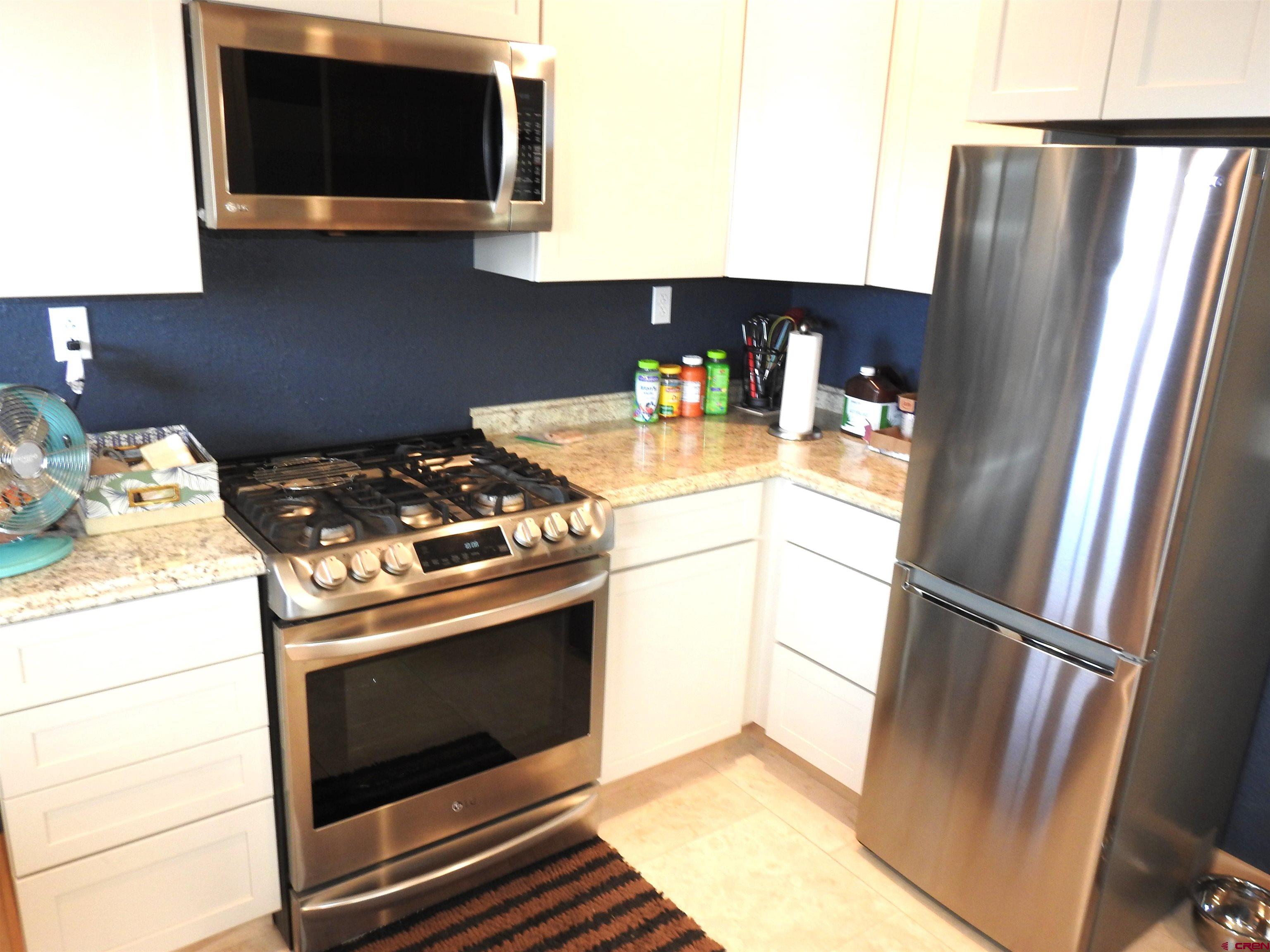 34099 Rd M Mancos, CO 81328 - Photo 12 of 37 a kitchen with a stove and a microwave