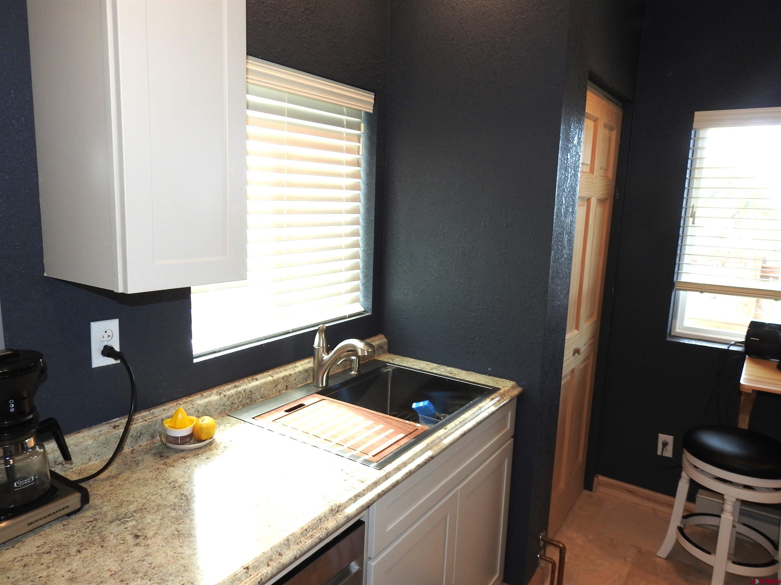 34099 Rd M Mancos, CO 81328 - Photo 14 of 37 a bathroom with a granite countertop sink and a window
