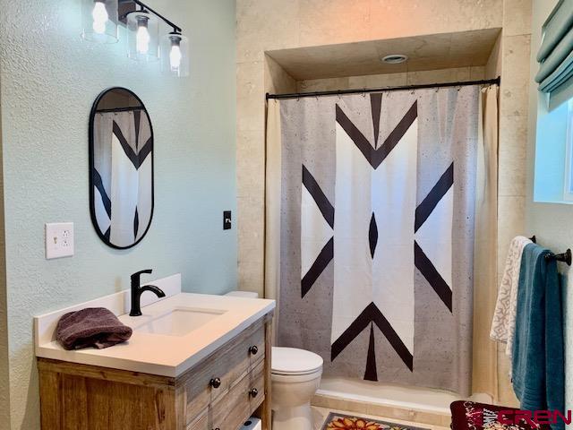 34099 Rd M Mancos, CO 81328 - Photo 25 of 37 a bathroom with a toilet sink and mirror