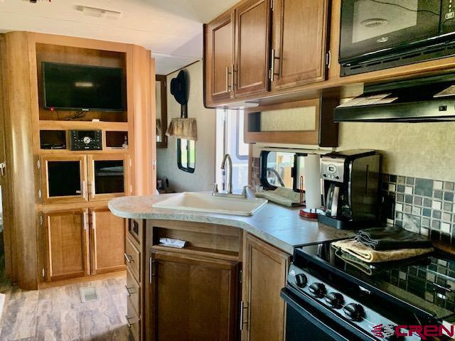 34099 Rd M Mancos, CO 81328 - Photo 35 of 37 a kitchen with stainless steel appliances granite countertop a stove and a microwave