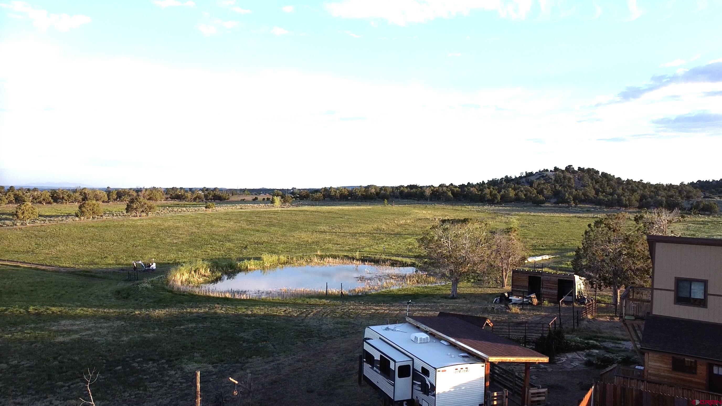 34099 Rd M Mancos, CO 81328 - Photo 5 of 37 a view of a lake with lawn chairs