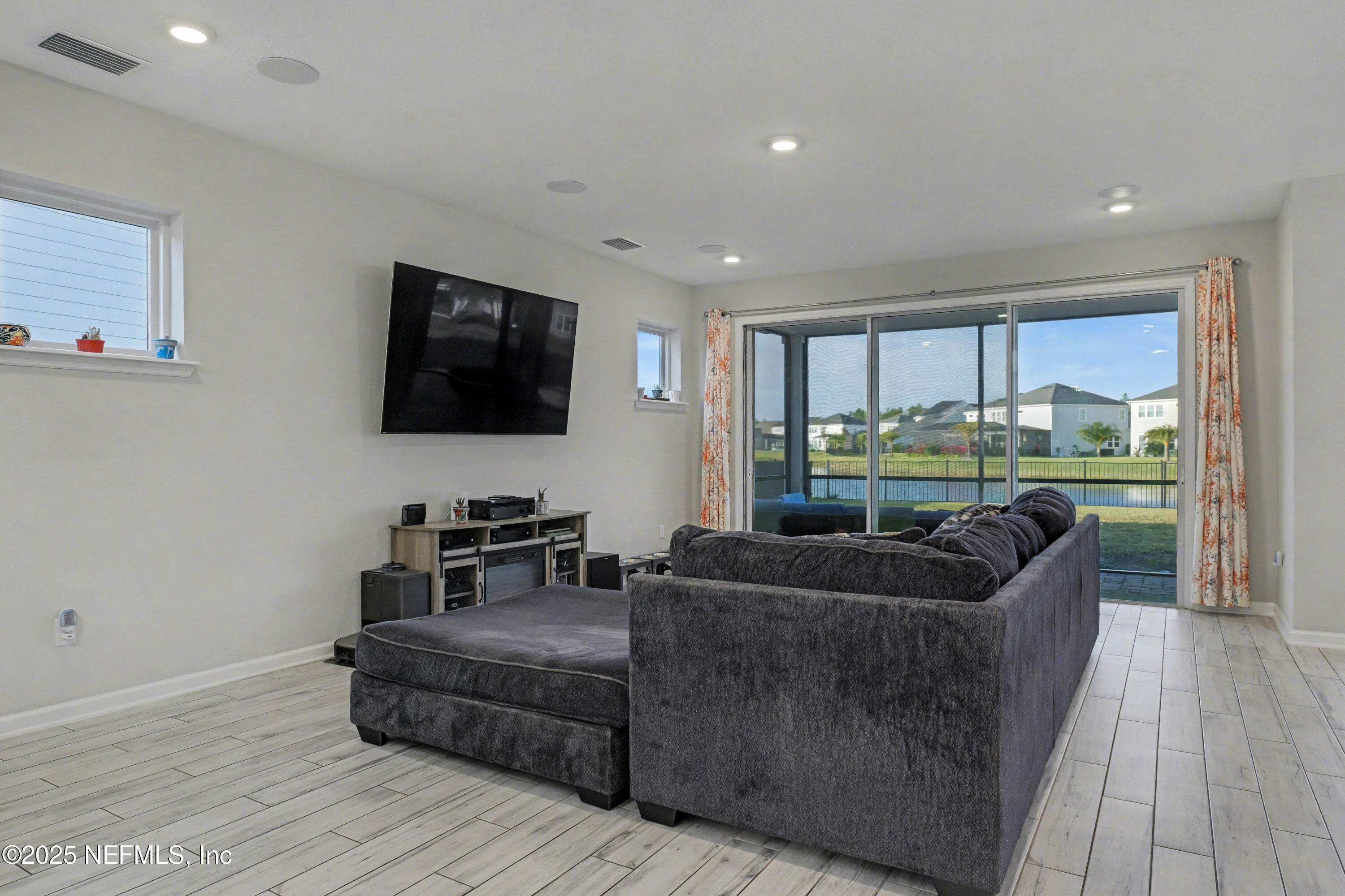 139 Spinner Drive Ponte Vedra, FL 32081 - Photo 12 of 67 a living room with furniture and a flat screen tv