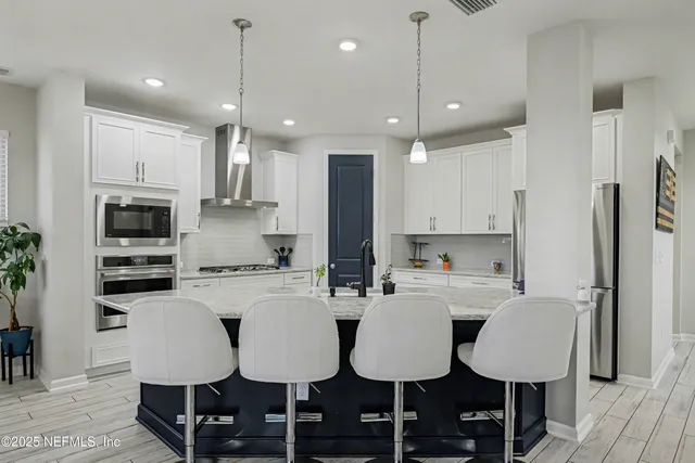 a dining room with furniture and wooden floor