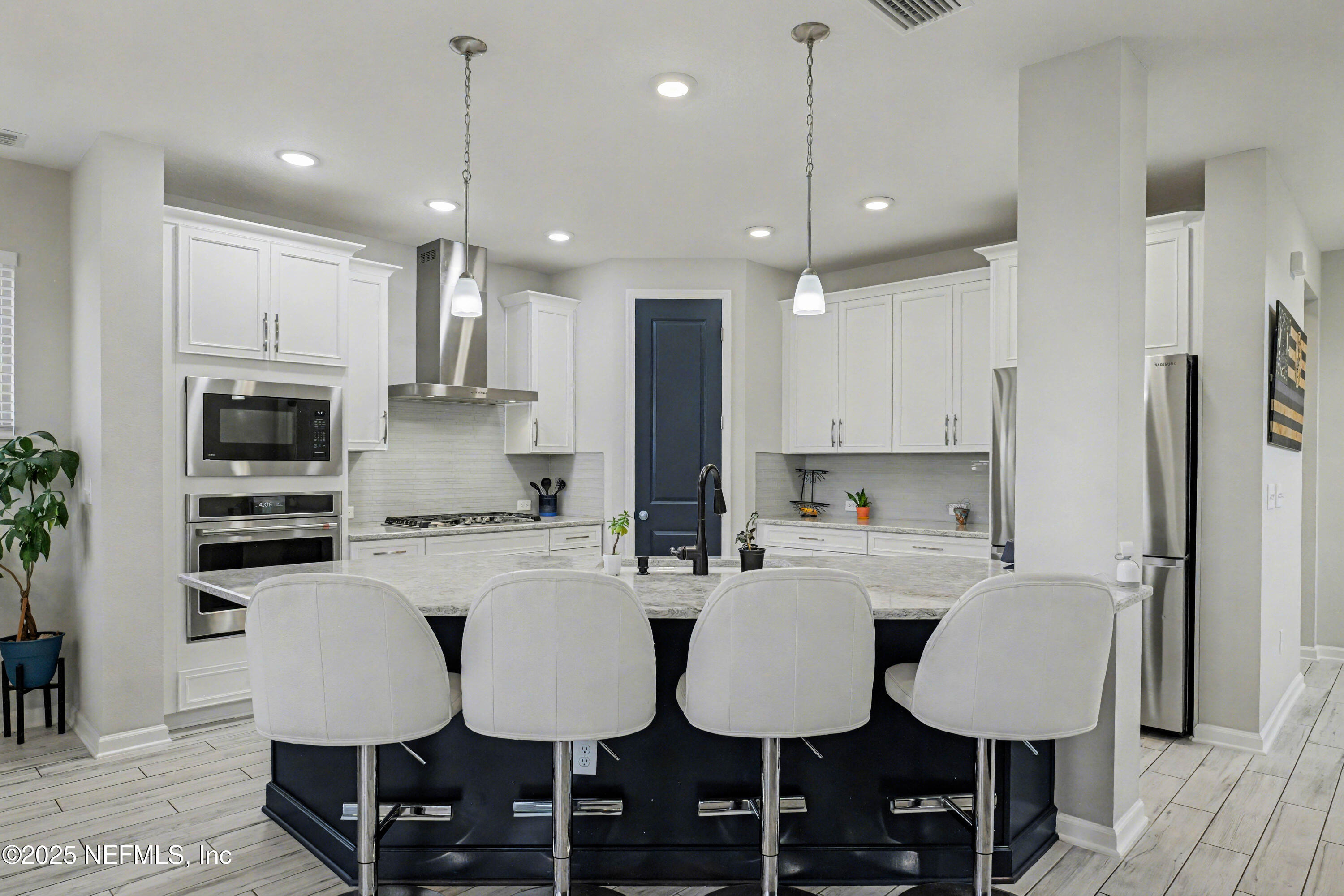 139 Spinner Drive Ponte Vedra, FL 32081 - Photo 14 of 67 a kitchen with stainless steel appliances a dining table chairs refrigerator sink and cabinets