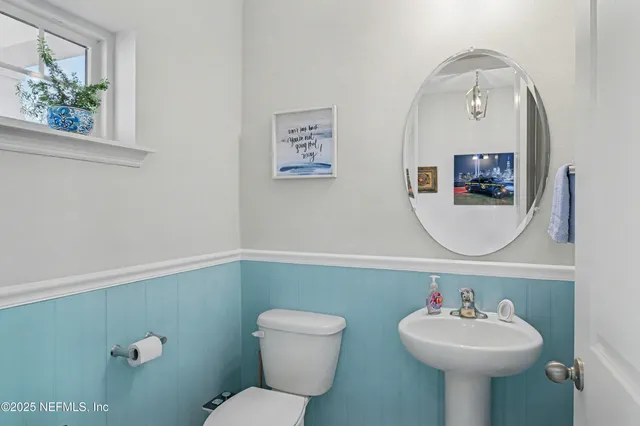 a bedroom with a large bed and ceiling fan