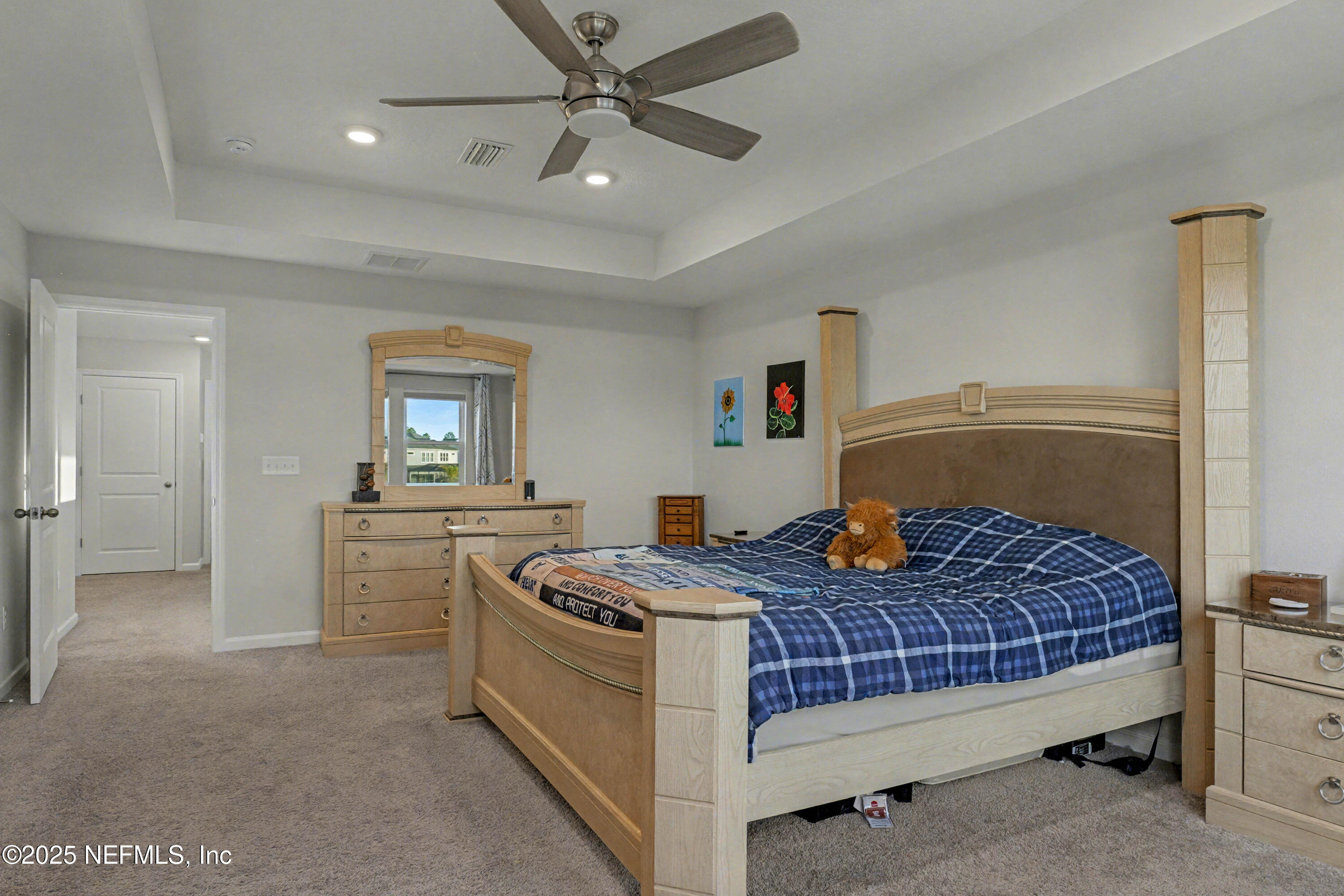 139 Spinner Drive Ponte Vedra, FL 32081 - Photo 23 of 67 a bedroom with a bed and a chandelier