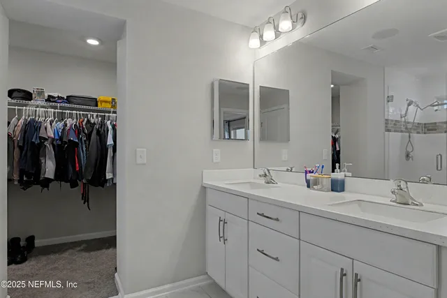a bathroom with a granite countertop shower and a sink