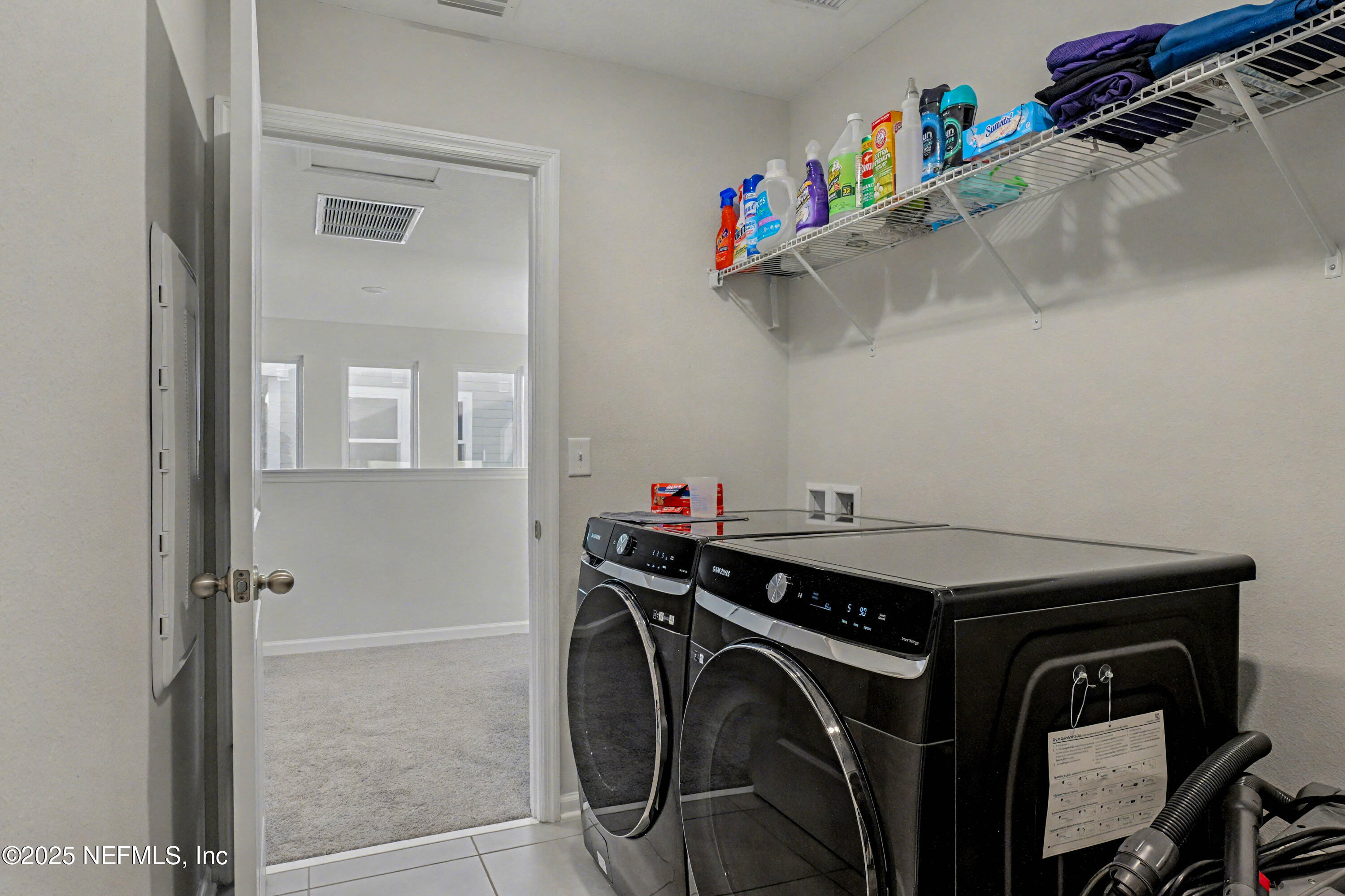 139 Spinner Drive Ponte Vedra, FL 32081 - Photo 39 of 67 a utility room with dryer washer and a view of living room