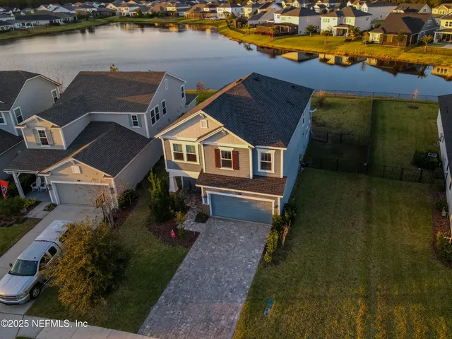 an aerial view of house with lake view