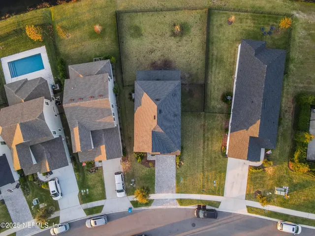an aerial view of residential houses with outdoor space