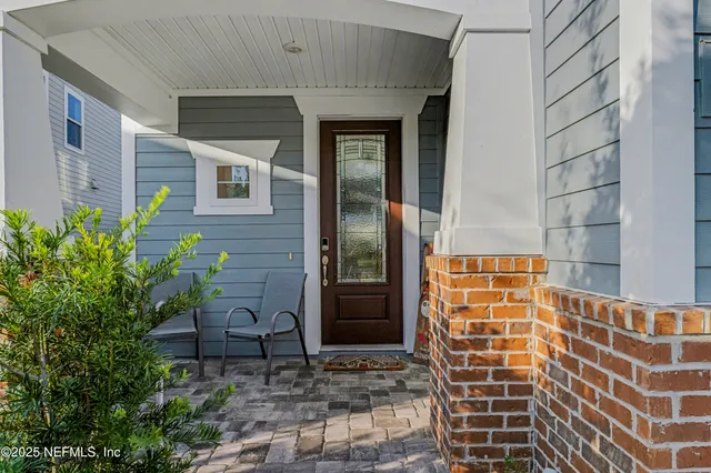 a view of hallway with wooden floor and dining table