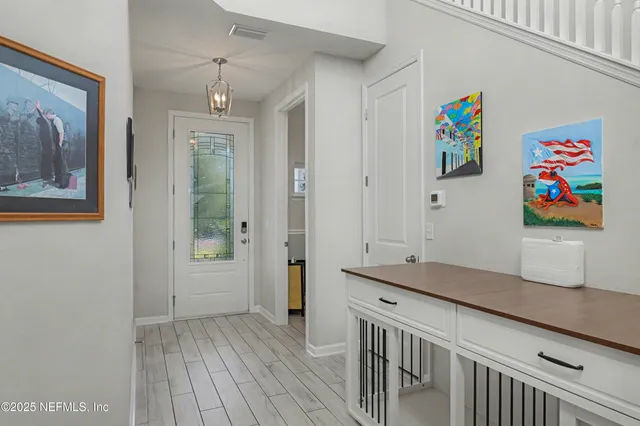 a view of entryway with wooden floor and stairs