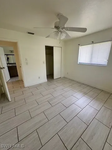 a view of a livingroom with wooden floor and a ceiling fan