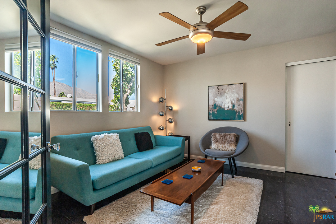 1805 Sandcliff Road Palm Springs, CA 92264 - Photo 12 of 51 a living room with furniture a window and a chandelier
