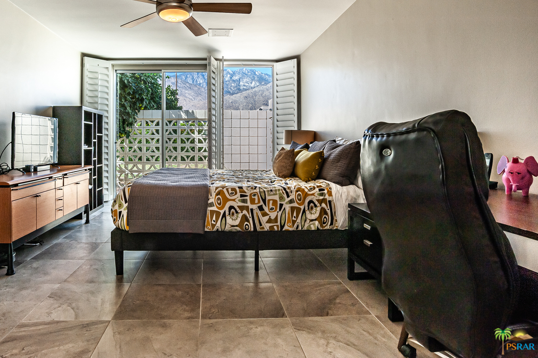 1805 Sandcliff Road Palm Springs, CA 92264 - Photo 28 of 51 a bedroom with a bed and large windows