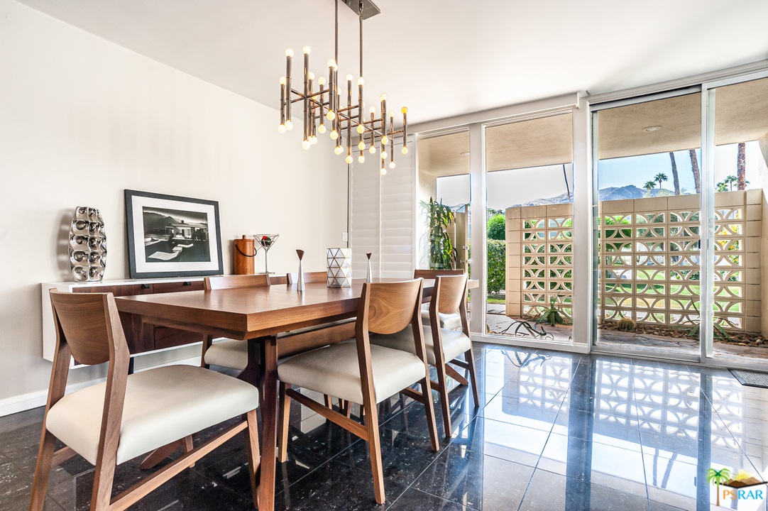 1805 Sandcliff Road Palm Springs, CA 92264 - Photo 5 of 51 a dining room with furniture a chandelier and window