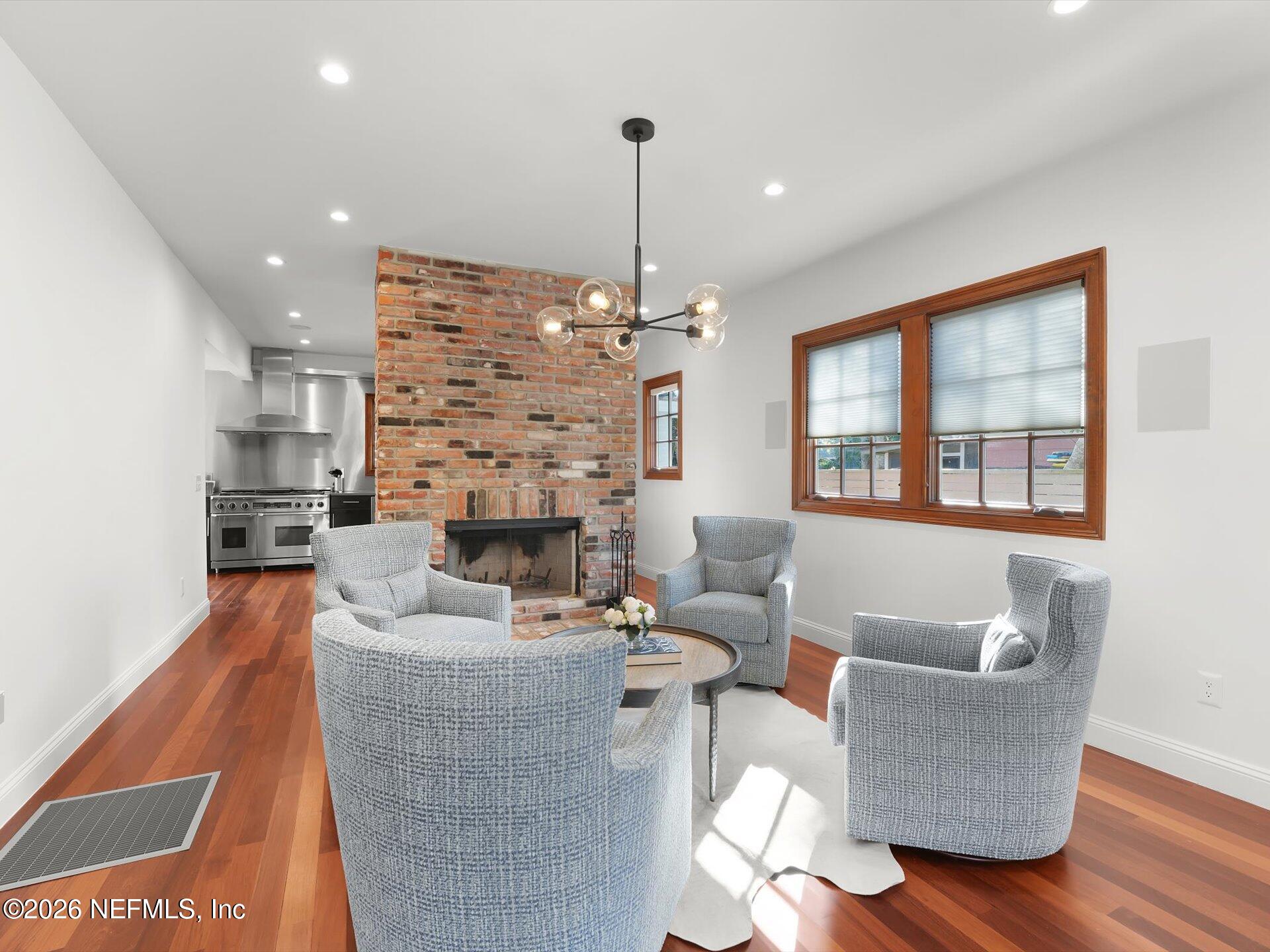 322 6th Street Atlantic Beach, FL 32233 - Photo 11 of 45 a living room with fireplace furniture and a chandelier
