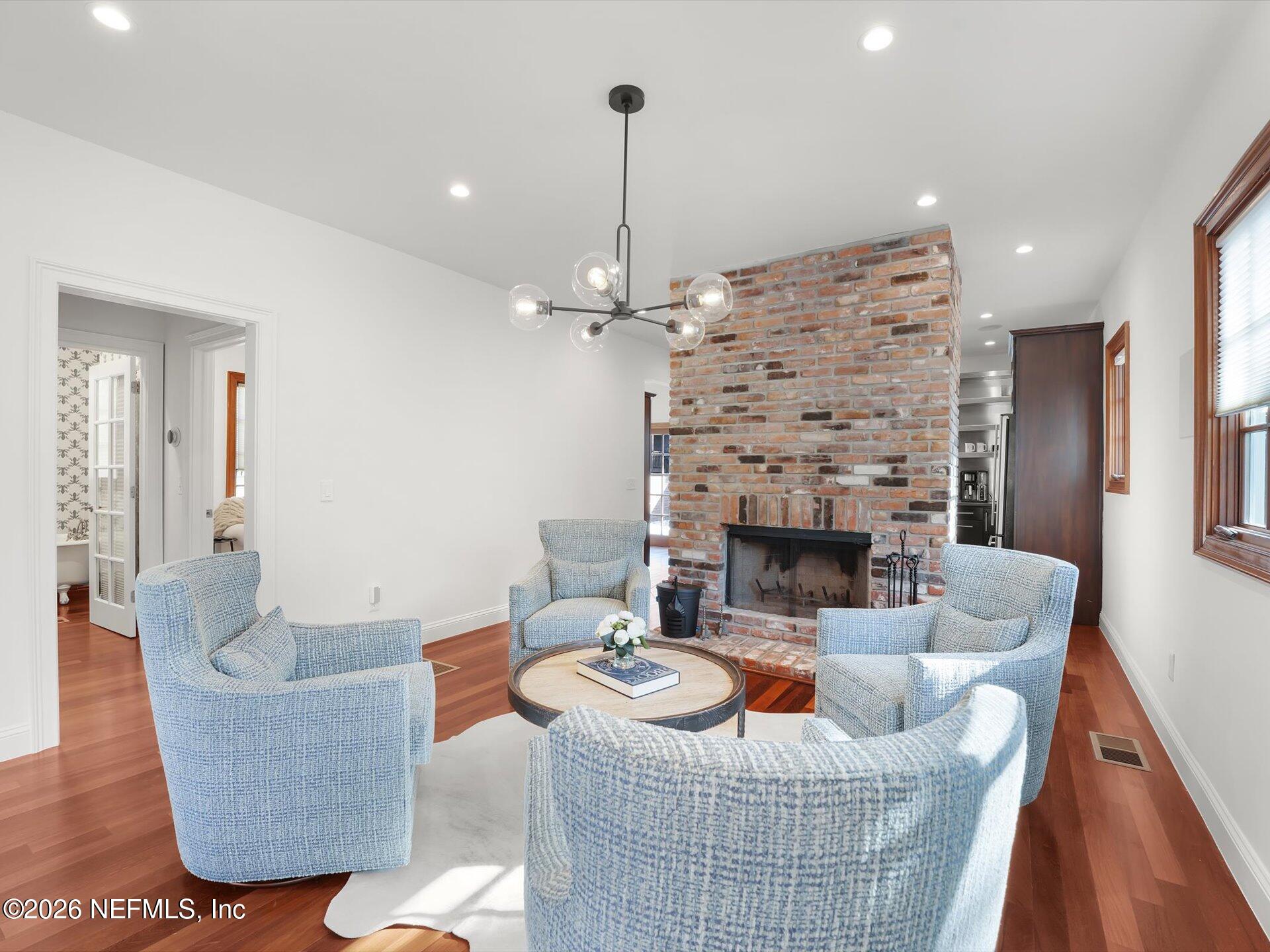 322 6th Street Atlantic Beach, FL 32233 - Photo 13 of 45 a living room with furniture a fireplace and a chandelier