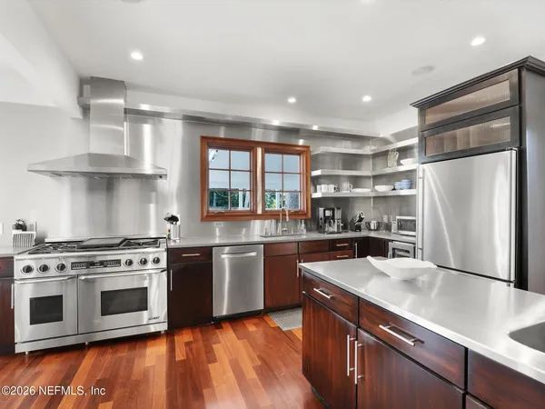 a kitchen with stainless steel appliances granite countertop a stove sink and refrigerator