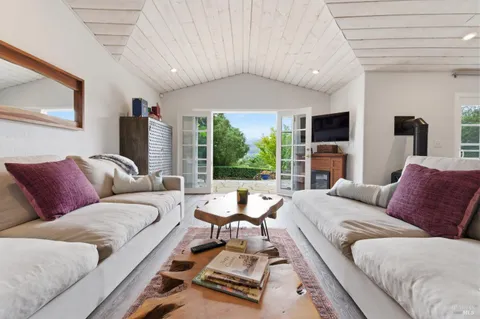 a living room with furniture and kitchen view