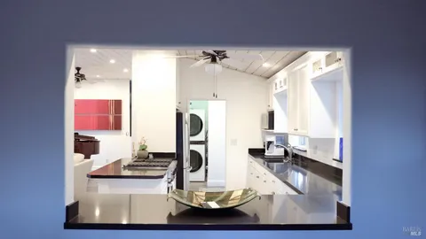 a living room with furniture a flat screen tv and a large window