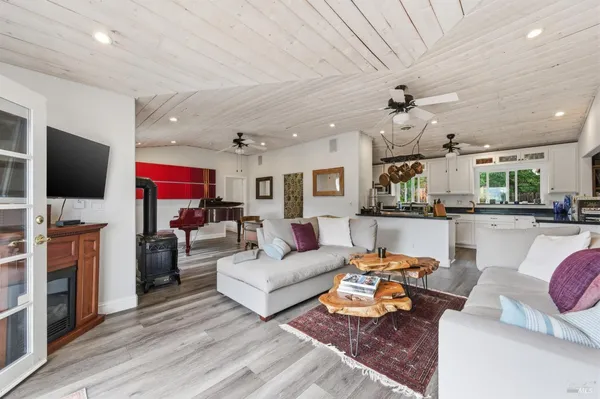 a kitchen with stainless steel appliances granite countertop a sink a stove and a refrigerator