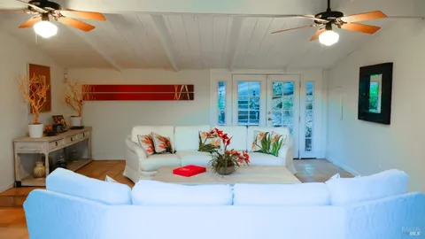 a living room with furniture and kitchen view