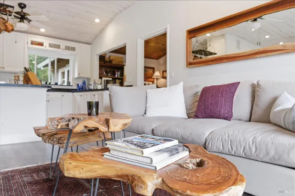 a living room with lots of furniture and kitchen view