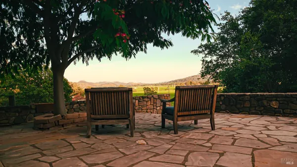 a view of house with backyard seating and patio