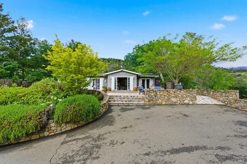 a view of a house with backyard porch and sitting area