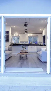 a living room with stainless steel appliances kitchen island granite countertop furniture and a kitchen view