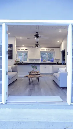 a living room with stainless steel appliances kitchen island granite countertop furniture and a kitchen view