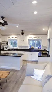 a view of a house with backyard porch and sitting area