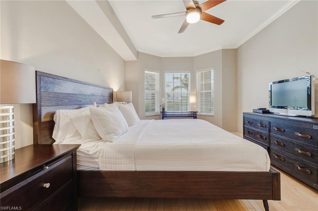 401 Bayfront Place, Unit 3303 Naples, FL 34102 - Photo 12 of 22 a bedroom with a bed and a flat tv screen on dresser