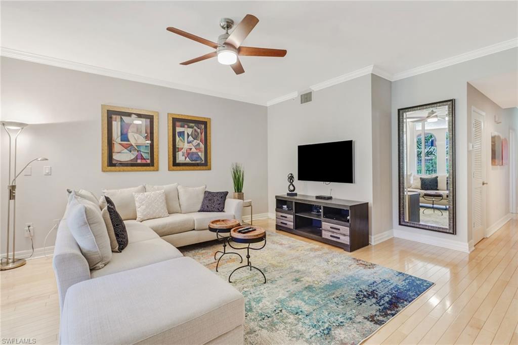 401 Bayfront Place, Unit 3303 Naples, FL 34102 - Photo 2 of 22 a living room with furniture and a flat screen tv